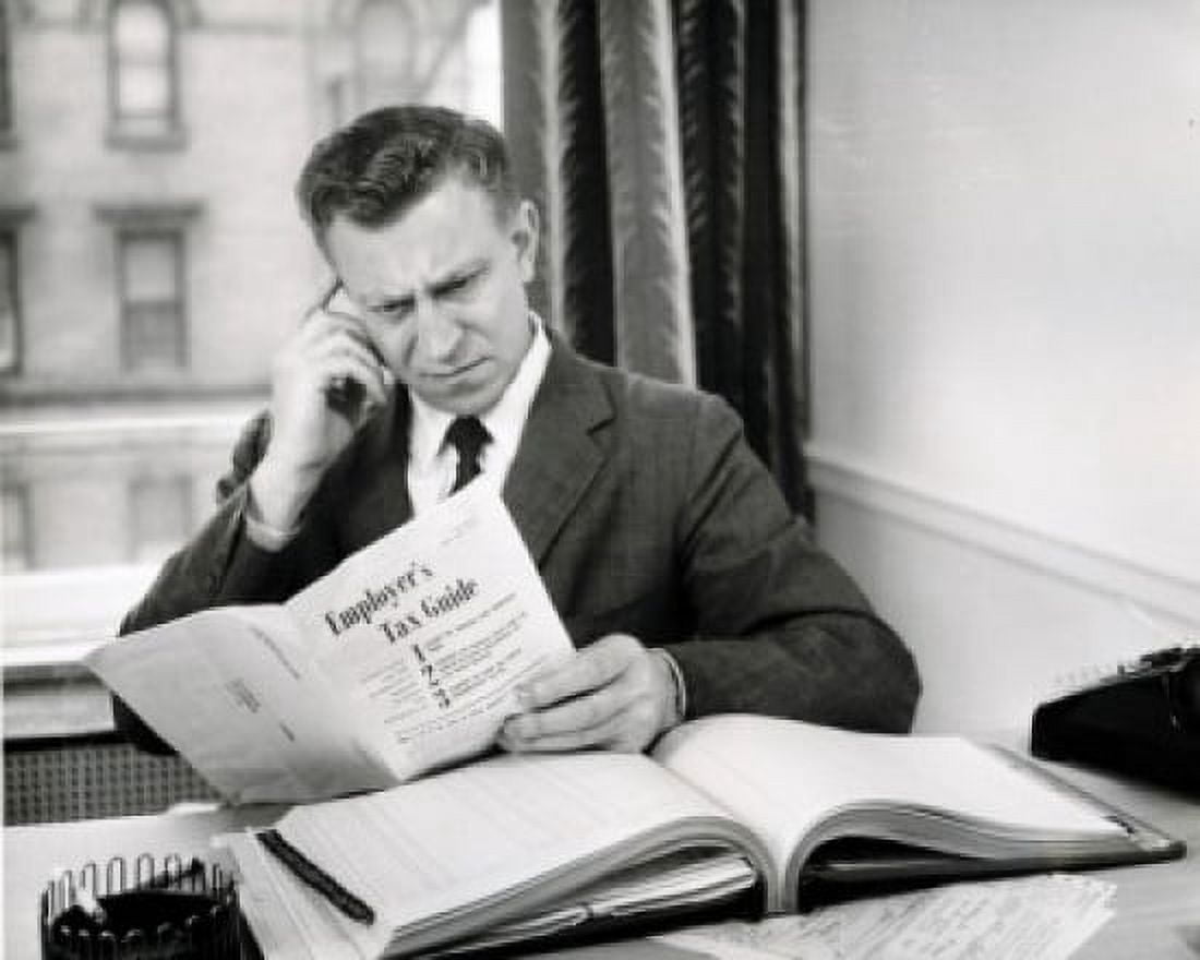 Businessman reading tax guide Canvas Art - (18 x 24)