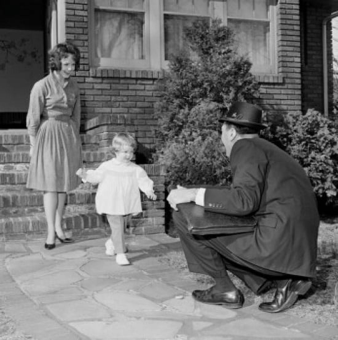 Businessman saying hello to wife and young daughter as he comes back from work Canvas Art - (24 x 36)