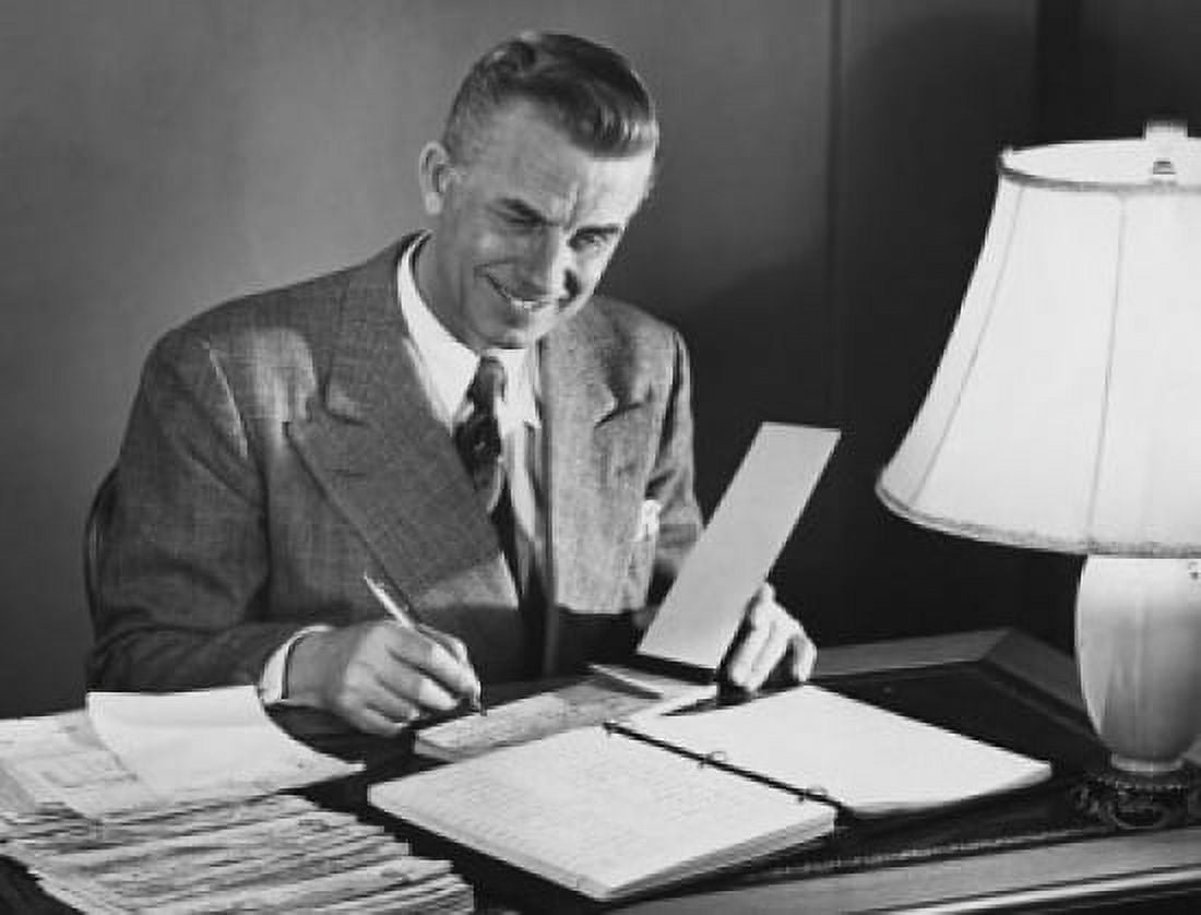 Businessman signing a check in an office Canvas Art - (24 x 36)