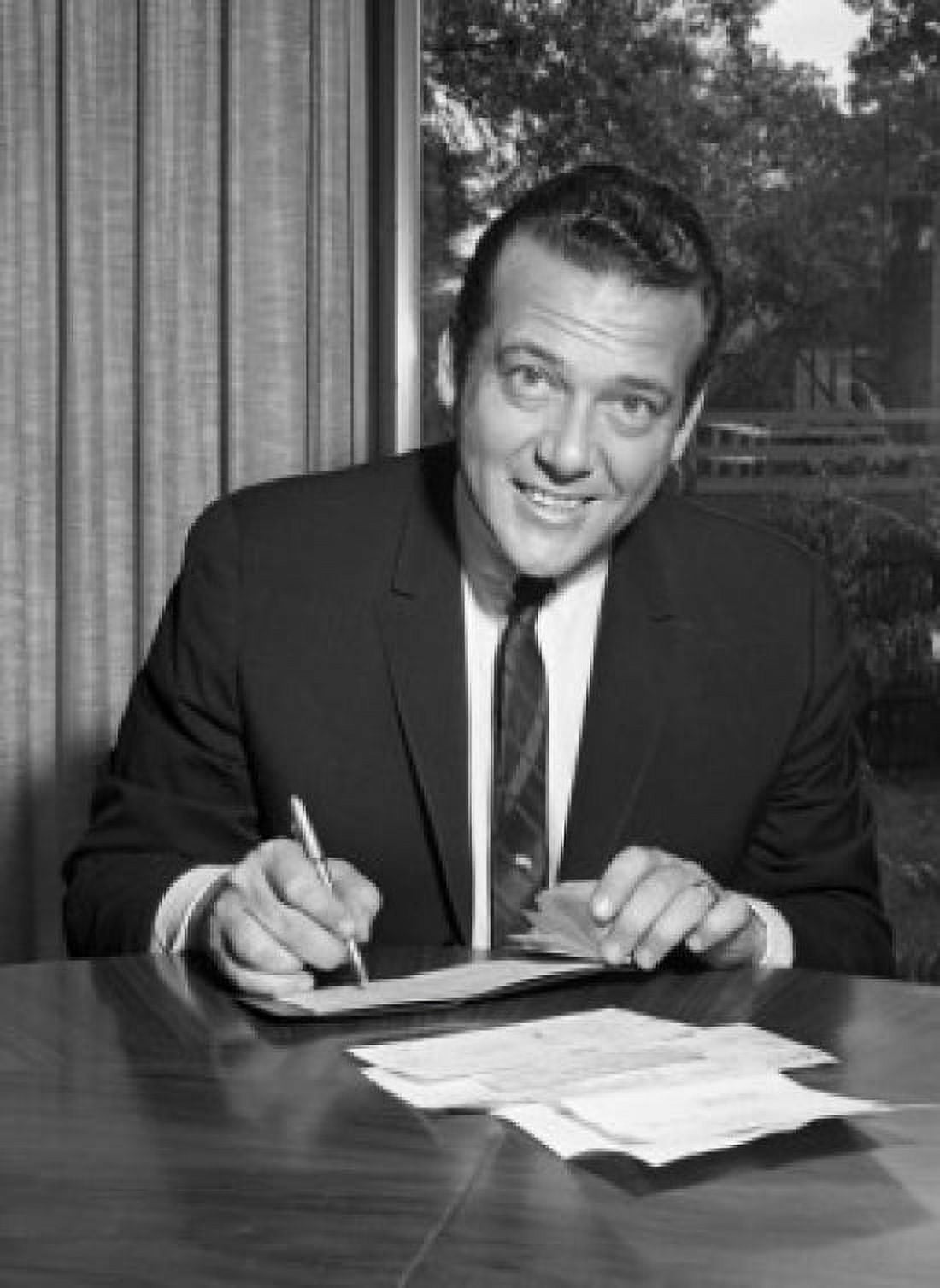 Businessman signing documents and looking at camera Canvas Art - (18 x 24)