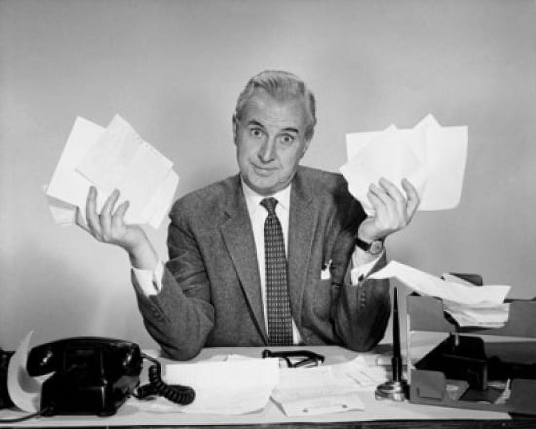 Businessman sitting at a desk and holding documents Canvas Art - (24 x 36)