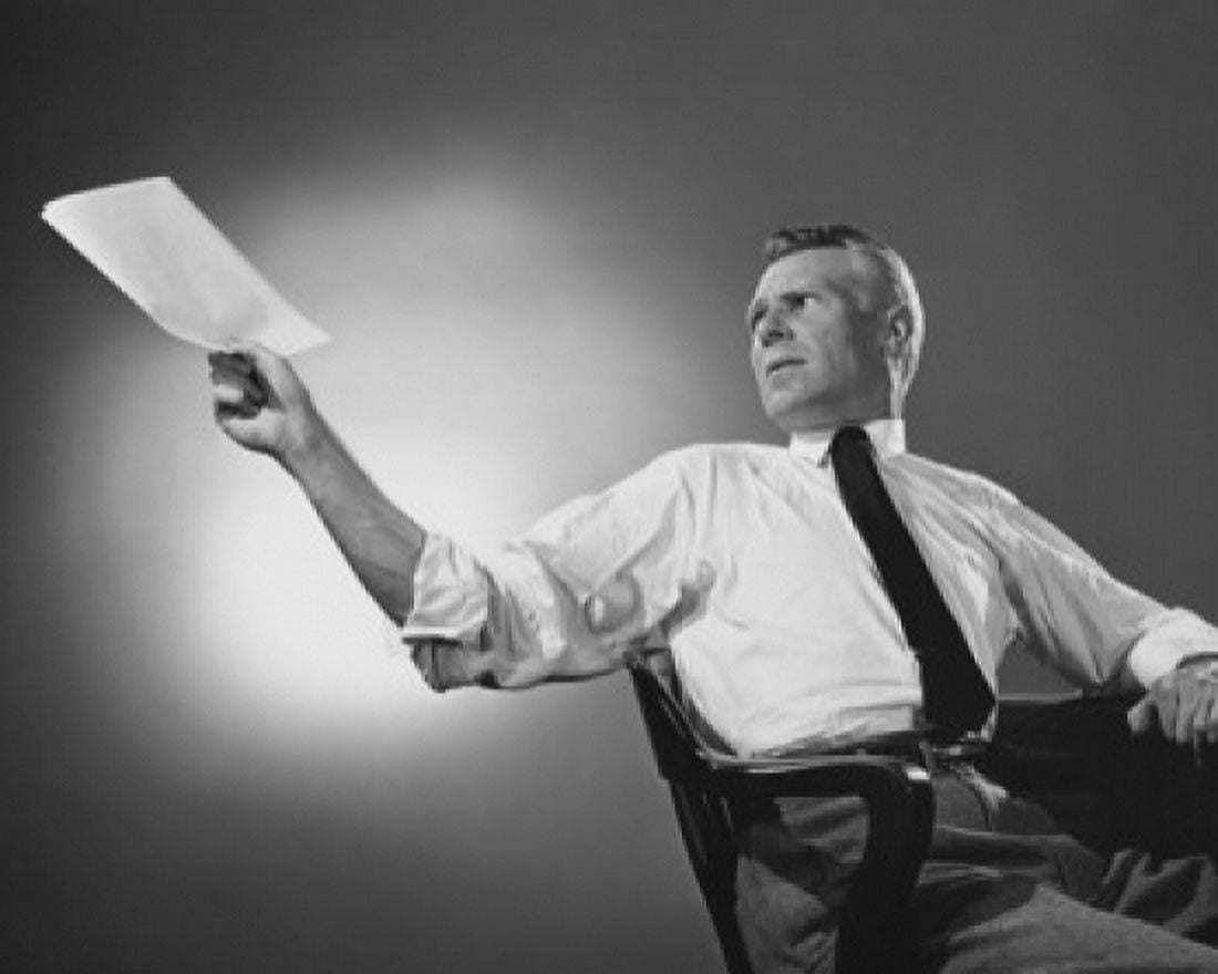Businessman sitting at a desk and holding documents in an office Canvas Art - (24 x 36)