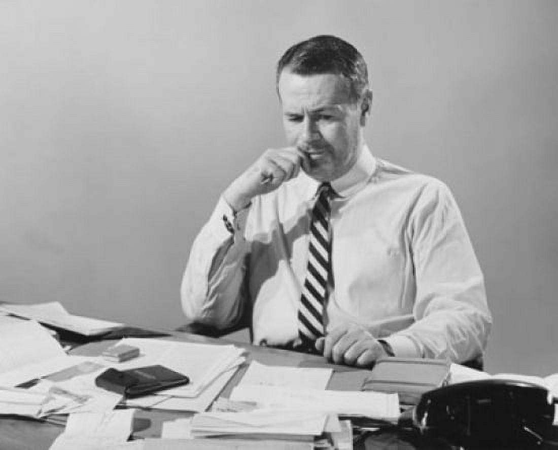 Businessman sitting at a desk and looking serious Canvas Art - (18 x 24)