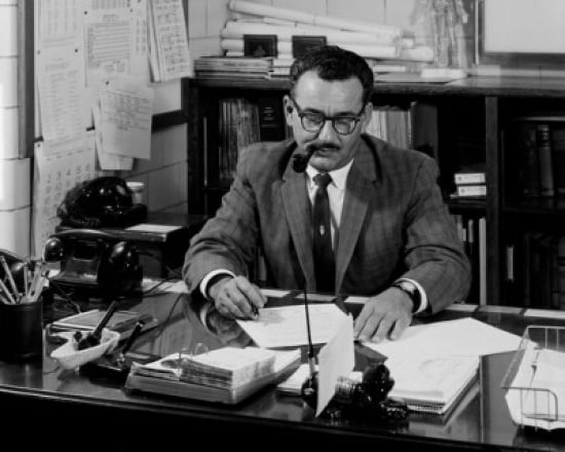 Businessman sitting at desk and reading document Canvas Art - (18 x 24)
