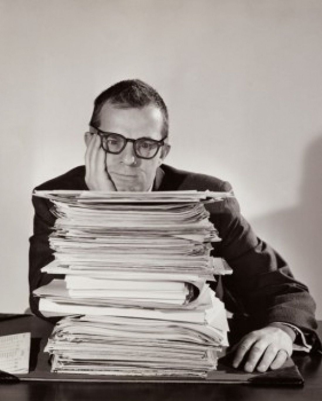 Businessman sitting behind a stack of file Canvas Art - (24 x 36)