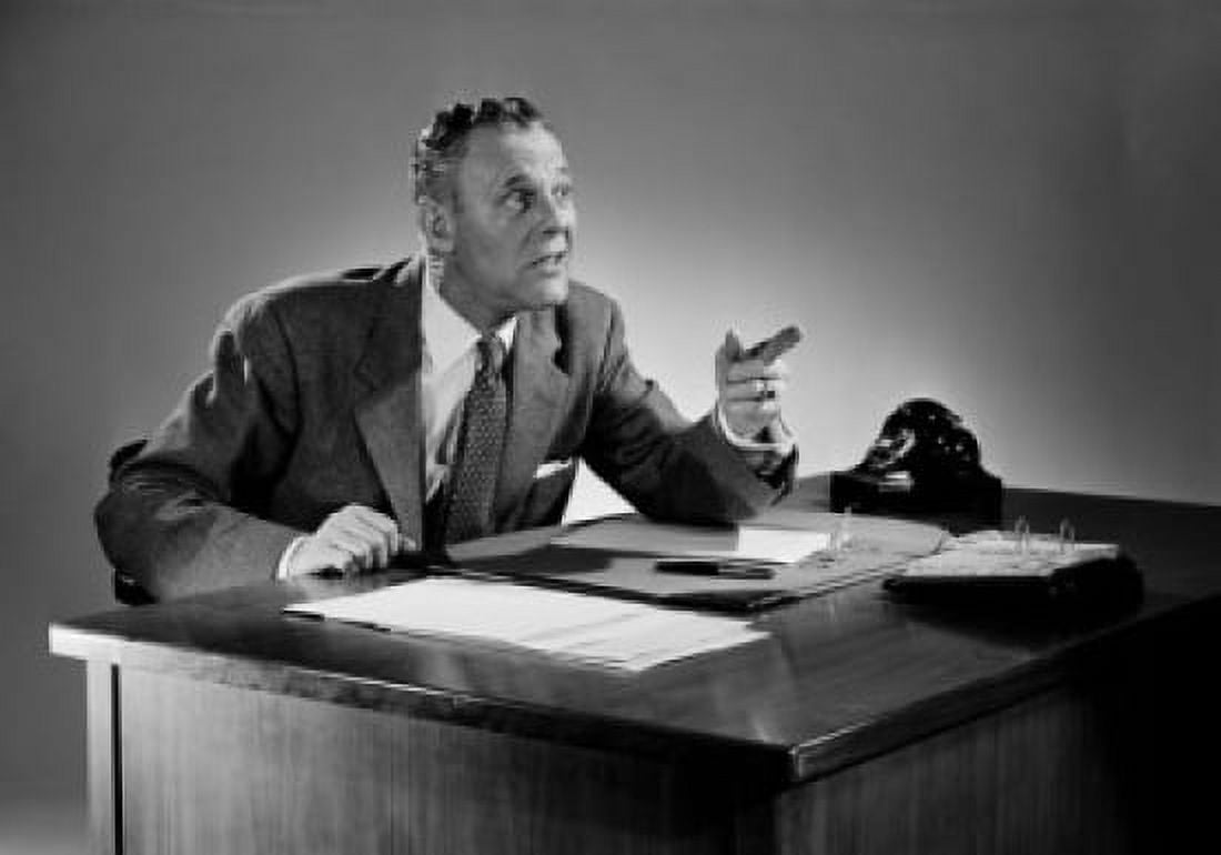 Businessman sitting near desk and pointing Canvas Art - (24 x 36)