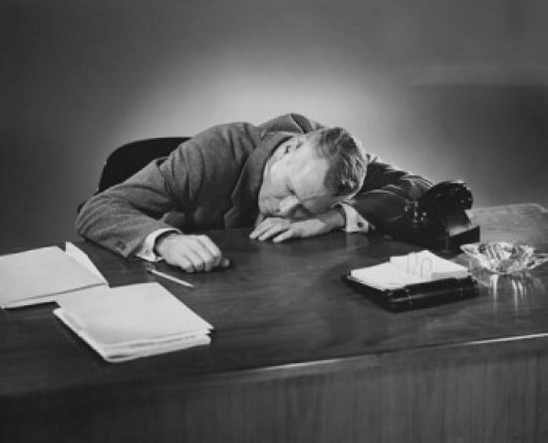 Businessman sleeping at a desk in an office Canvas Art - (18 x 24)