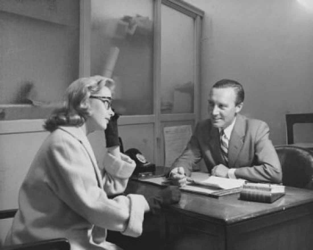 Businessman talking to a mid adult woman in an office Canvas Art - (18 x 24)