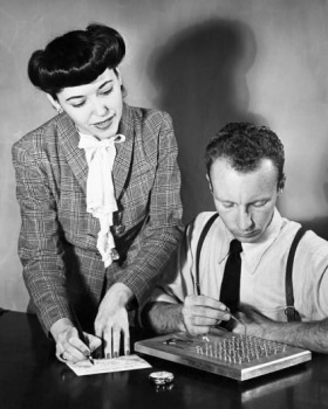 Businessman undergoing a manual dexterity test with a businesswoman standing beside him Canvas Art - (18 x 24)
