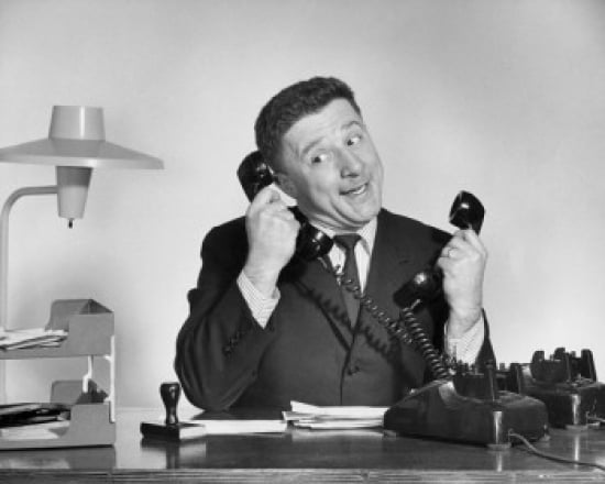 Businessman using two telephones Canvas Art - (18 x 24)