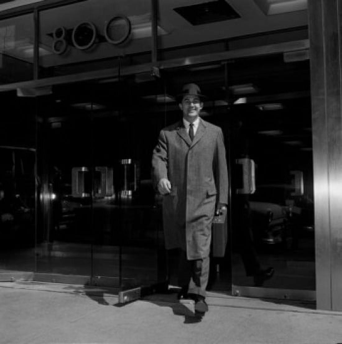 Businessman walking out of office building Canvas Art - (18 x 24)