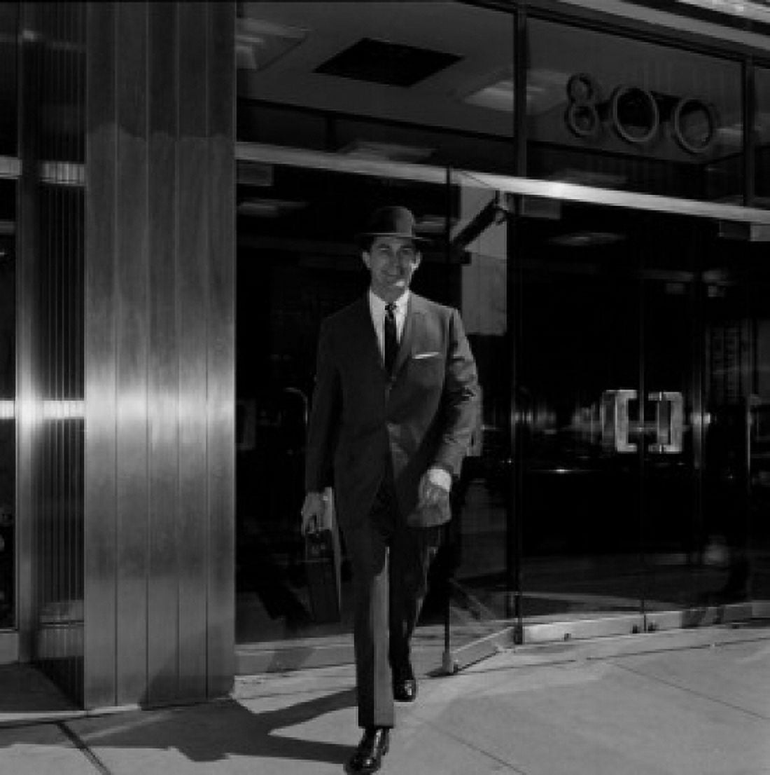 Businessman walking out of office building Canvas Art - (24 x 36)