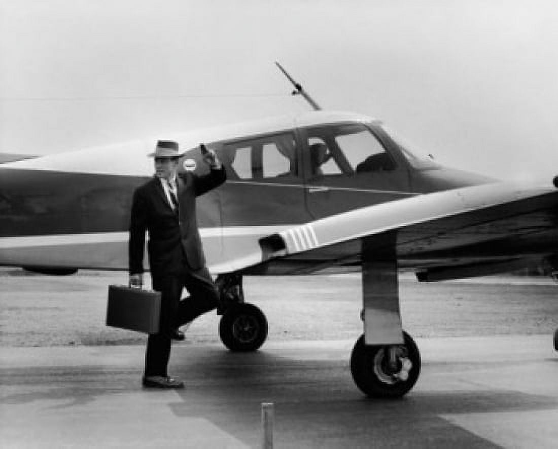 Businessman waving his hand near an aircraft Canvas Art - (18 x 24)