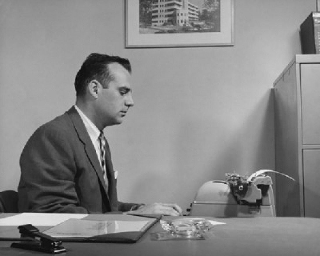 Businessman working on a typewriter Canvas Art - (18 x 24)