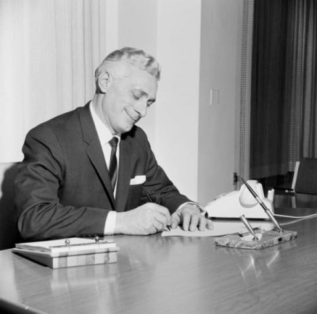 Businessman writing behind desk Canvas Art - (24 x 36)