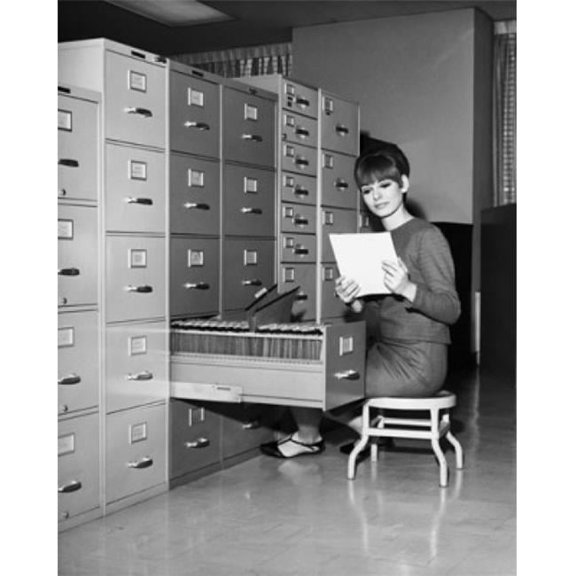Businesswoman Reading a Document Beside a Filing Cabinet Poster Print