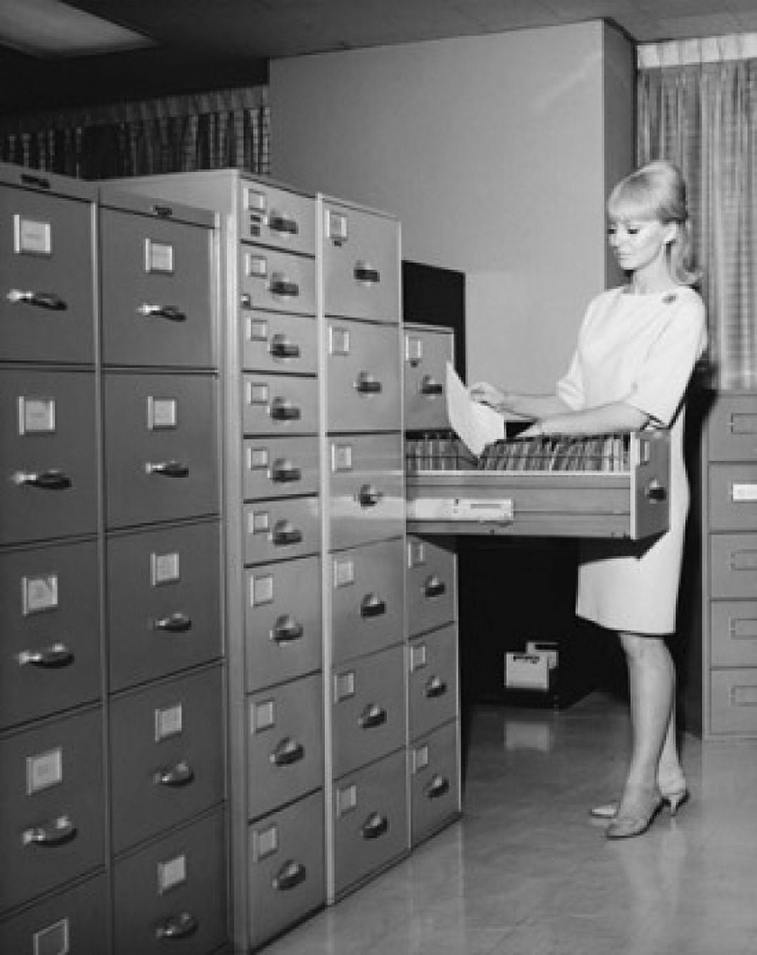 Businesswoman arranging documents in a filing cabinet Canvas Art - (18 x 24)