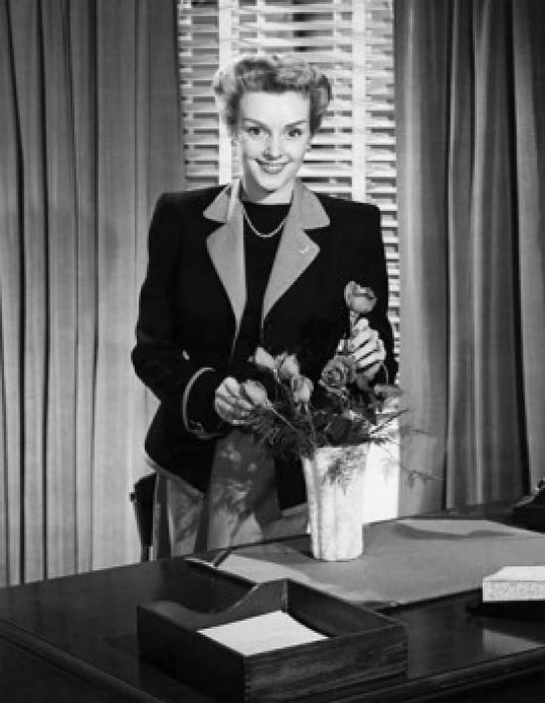 Businesswoman arranging flowers and smiling Canvas Art - (18 x 24)