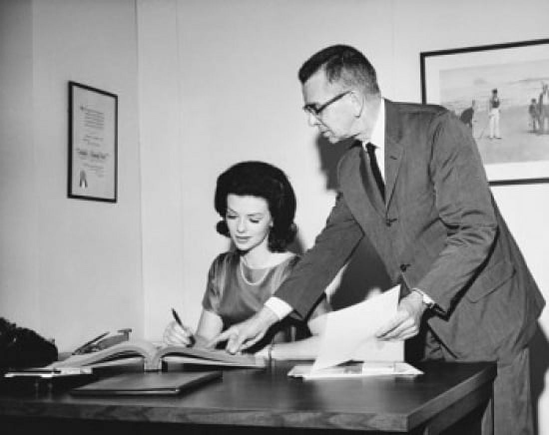 Businesswoman checking documents with a businessman standing beside her Canvas Art - (18 x 24)