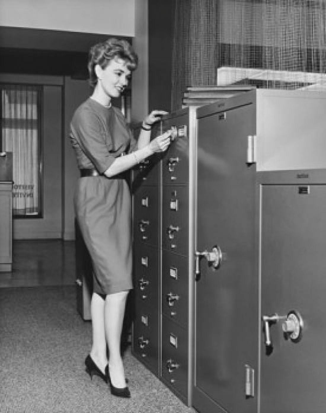 Businesswoman opening a combination lock Canvas Art - (18 x 24)