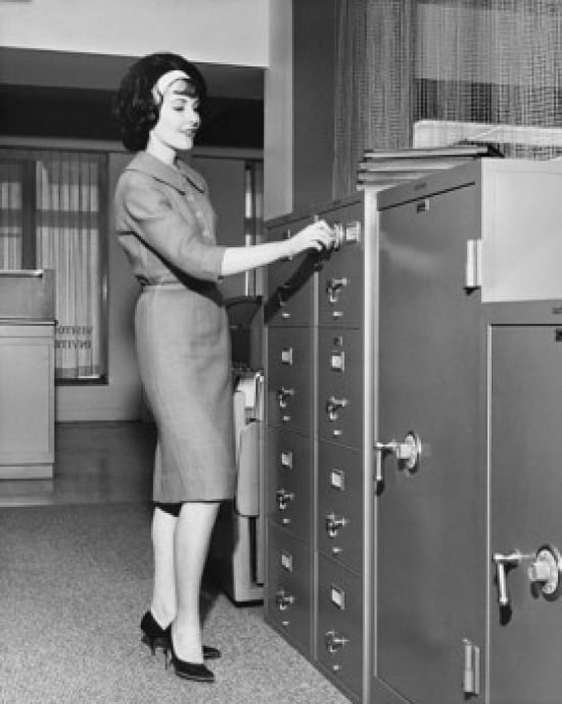 Businesswoman opening a filing cabinet Canvas Art - (24 x 36)