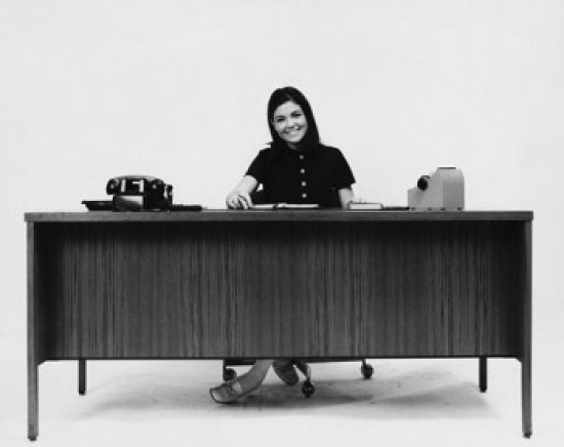 Businesswoman sitting at a desk and smiling in an office Canvas Art - (18 x 24)