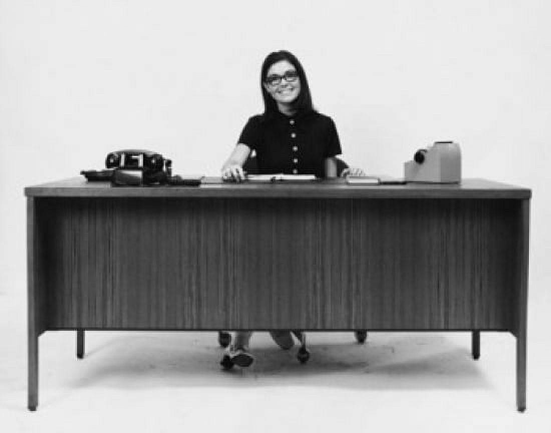 Businesswoman sitting at a desk and smiling in an office Canvas Art - (18 x 24)