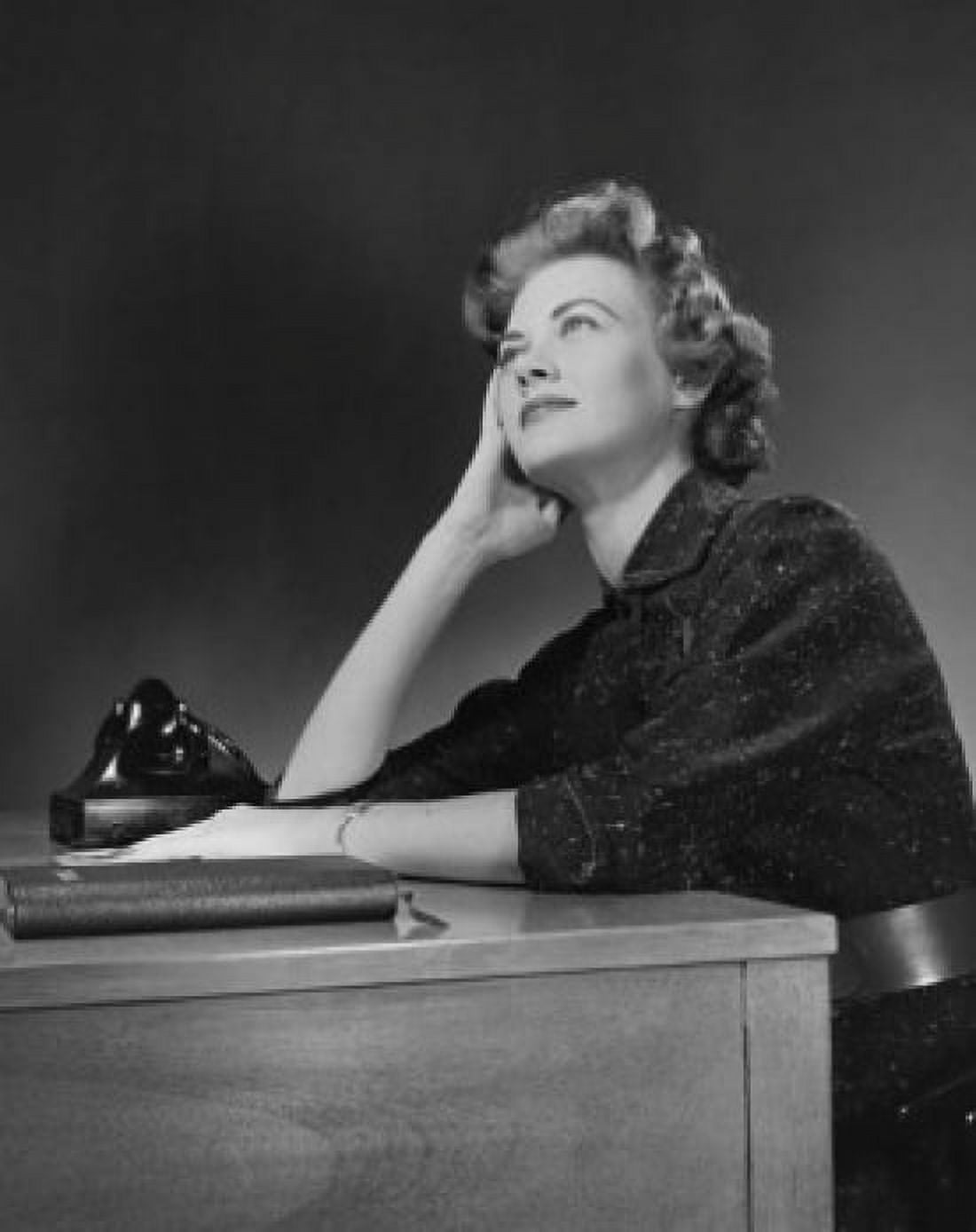 Businesswoman sitting at a desk and thinking in an office Canvas Art - (24 x 36)