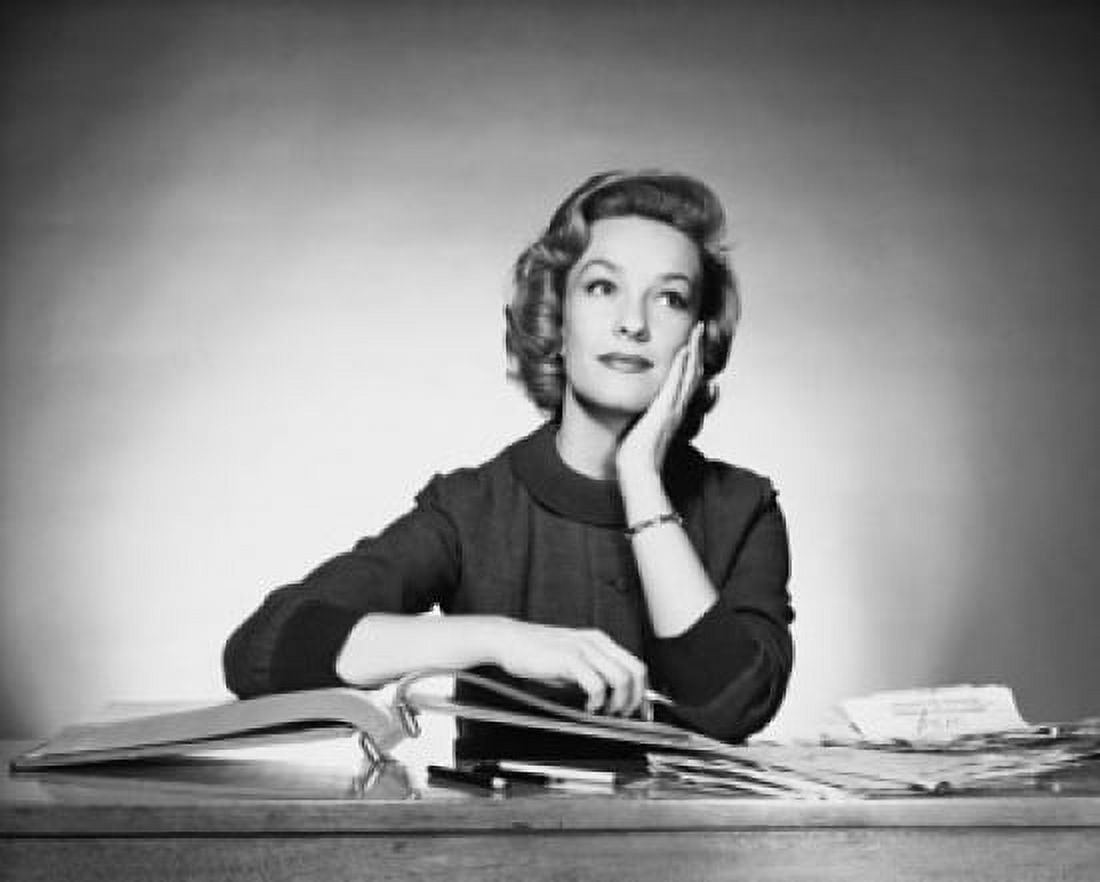 Businesswoman sitting at a desk in an office Canvas Art - (18 x 24)