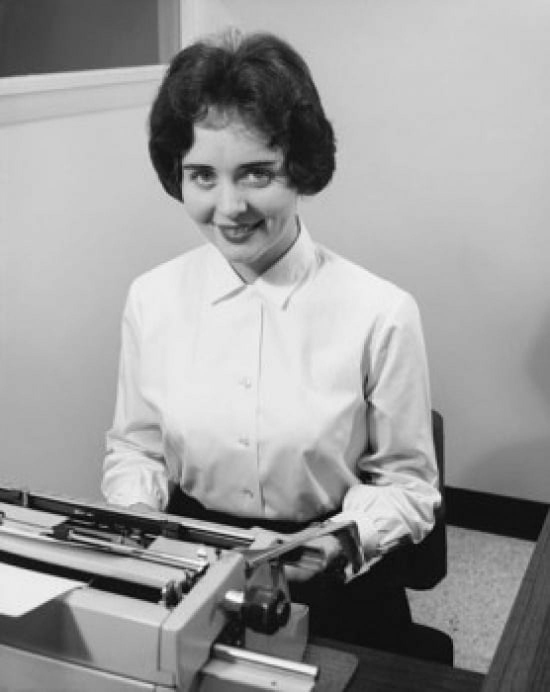 Businesswoman typing on a typewriter in an office Canvas Art - (18 x 24)