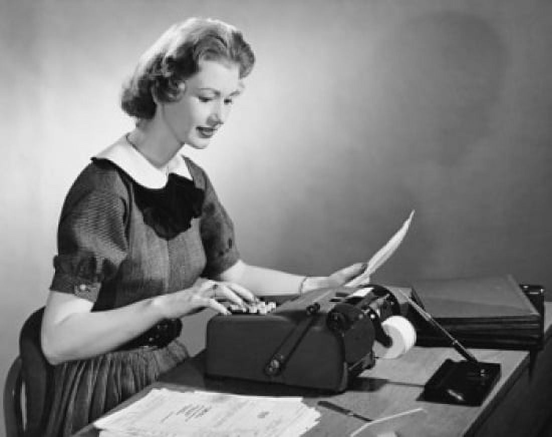 Businesswoman typing on a typewriter in an office Canvas Art - (18 x 24)