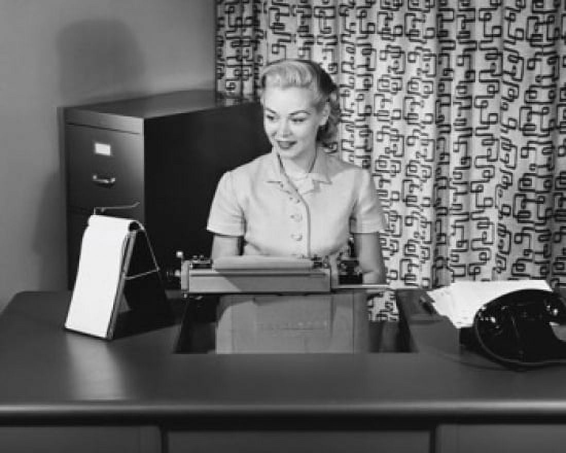 Businesswoman typing on a typewriter in an office Canvas Art - (18 x 24)