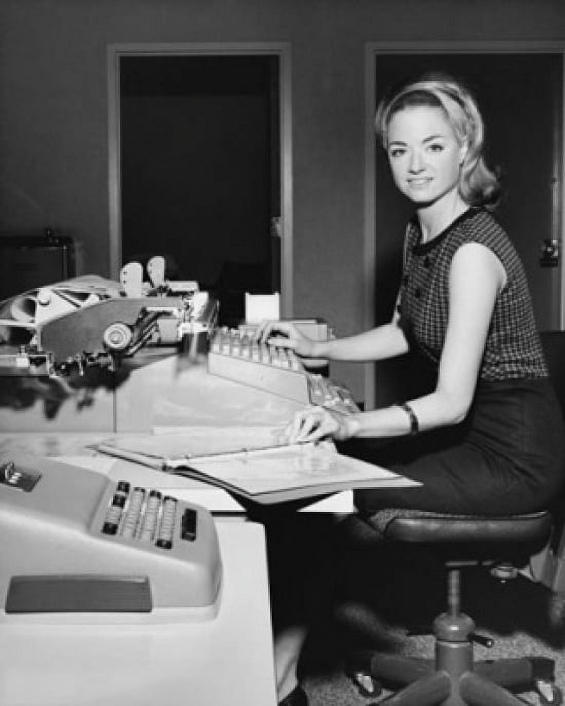 Businesswoman typing on a typewriter in an office Canvas Art - (24 x 36)