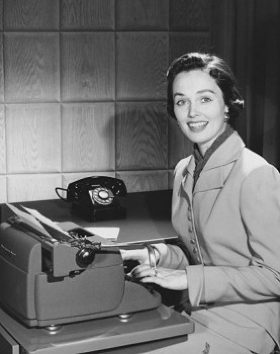 Businesswoman typing on a typewriter in an office Canvas Art - (24 x 36)
