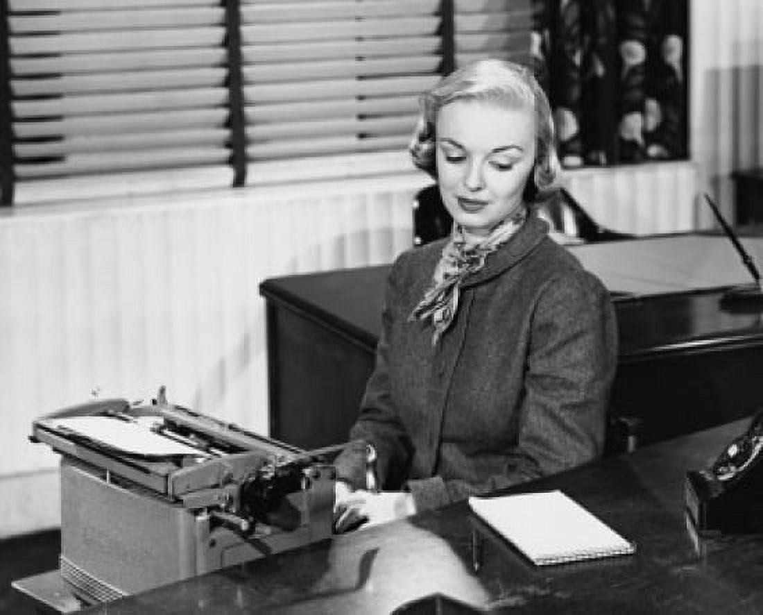 Businesswoman typing on a typewriter in an office Canvas Art - (24 x 36)