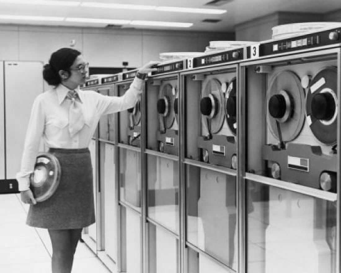 Businesswoman working with computer tape drives 1970 Canvas Art - (18 x 24)