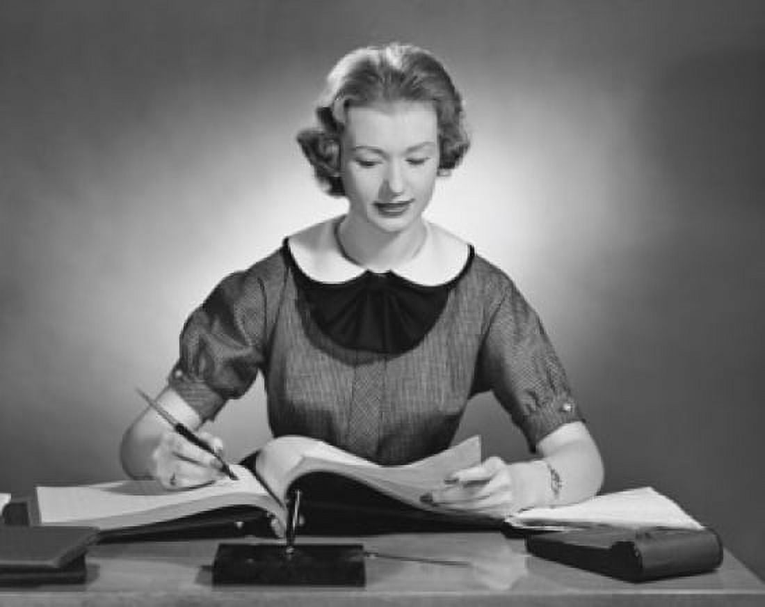 Businesswoman writing in a notebook with a pen in an office Canvas Art - (18 x 24)