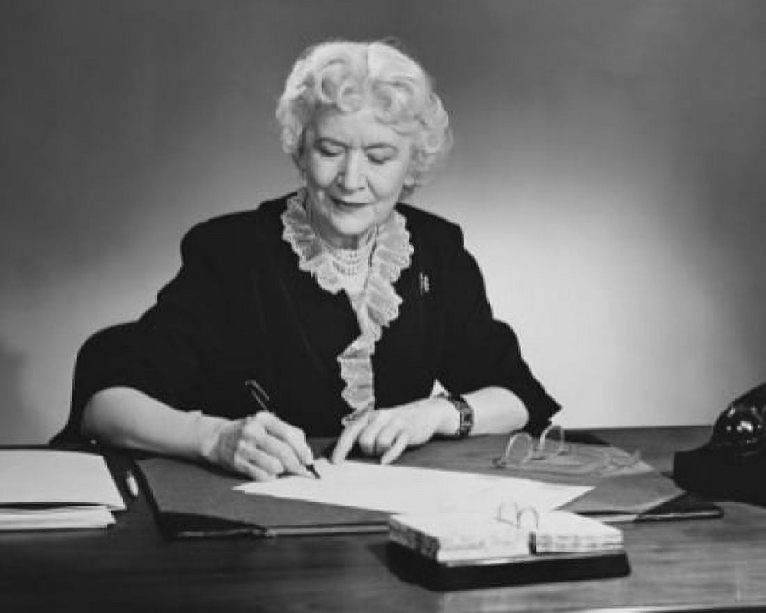 Businesswoman writing on documents with a pen in an office Canvas Art - (24 x 36)