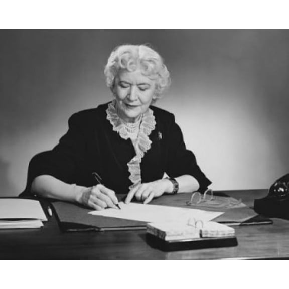 Businesswoman writing on documents with a pen in an office Canvas Art - (24 x 36)
