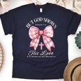 thumbnail image 1 of But God Shows His Love T-Shirt, Romans 5:8 Bible Verse Tee with Pink Bow, Navy, Size S, 1 of 6
