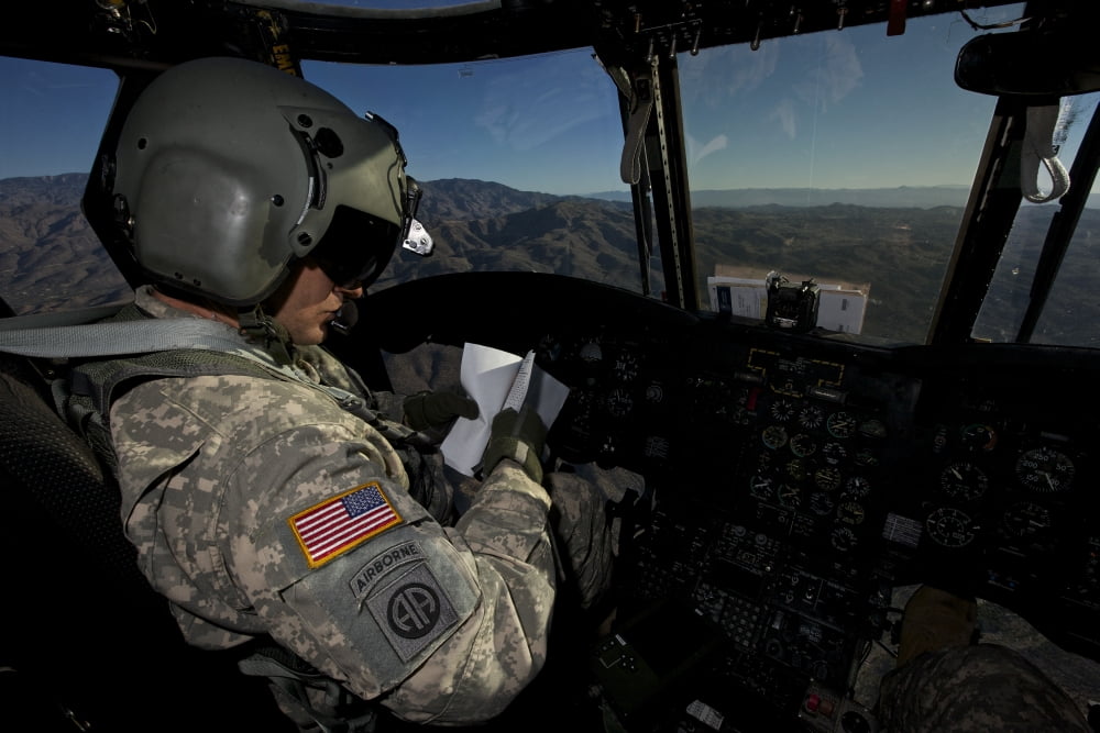 CH-47 Chinook pilot refers to his checklist while in flight Canvas Art - Terry MooreStocktrek Images (18 x 12)