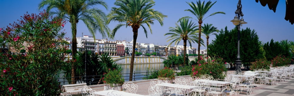 Cafe at the riverside Guadalquivir River Seville Seville Province Andalusia Spain Canvas Art - Panoramic Images (12 x 36)