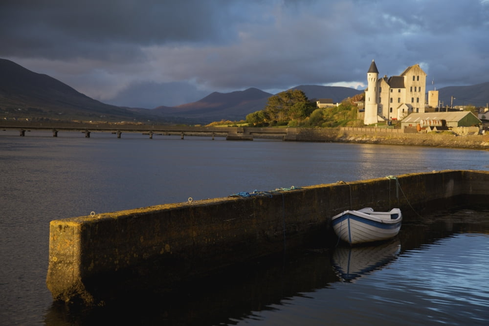 Caherciveen County Kerry Ireland The Old Barracks In Evening Light With A Row Boat Moored To The Harbour Wall Canvas Art - Patrick Swan Design Pics (38 x 24)