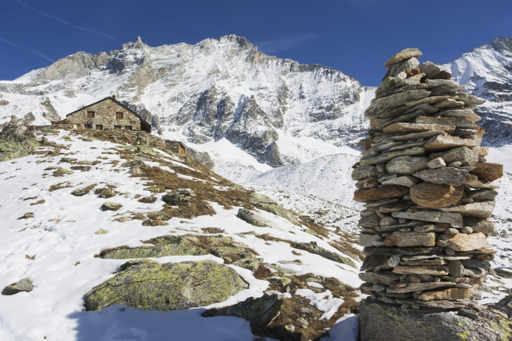 Cairns mark the way up to the Cabane Aripetta mountain refuge and autumn day with early snow Zinal Switzerland Canvas Art - Penny Kendall Design Pics (19 x 12)