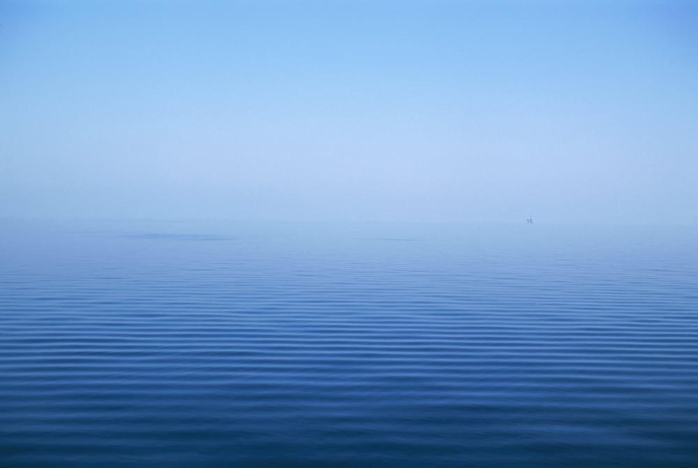Calm Blue Water Disappearing Into Horizon Canvas Art - Toby Adamson Design Pics (18 x 12)