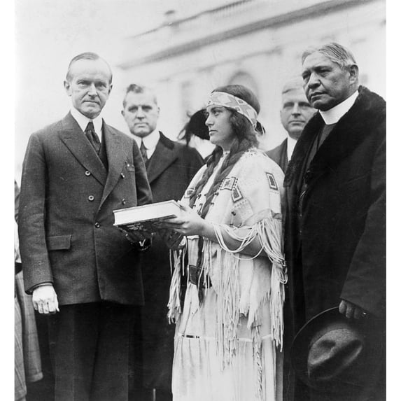 Calvin Coolidge. N30Th President Of The United States. Coolidge Is Presented With A Copy Of 'The Red Man In