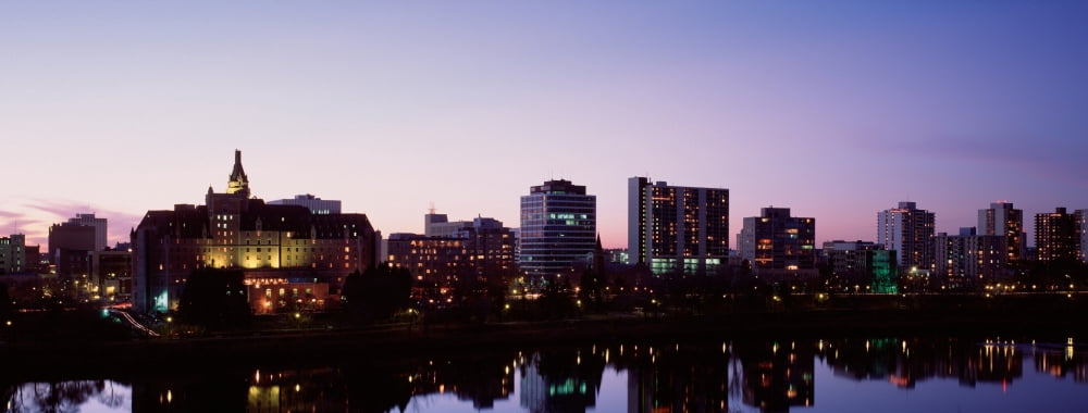 Canada Saskatchewan Saskatoon Buildings along a river Canvas Art - Panoramic Images (36 x 12)
