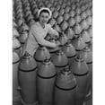 thumbnail image 1 of Canadian Woman Munitions Worker Tightening The Nose Plugs On 500-Pound Aerial Bombs. 1942-43 History, 1 of 2