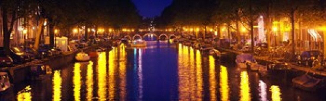 Canal at night Amsterdam Netherlands Canvas Art - Panoramic Images (18 x 6)
