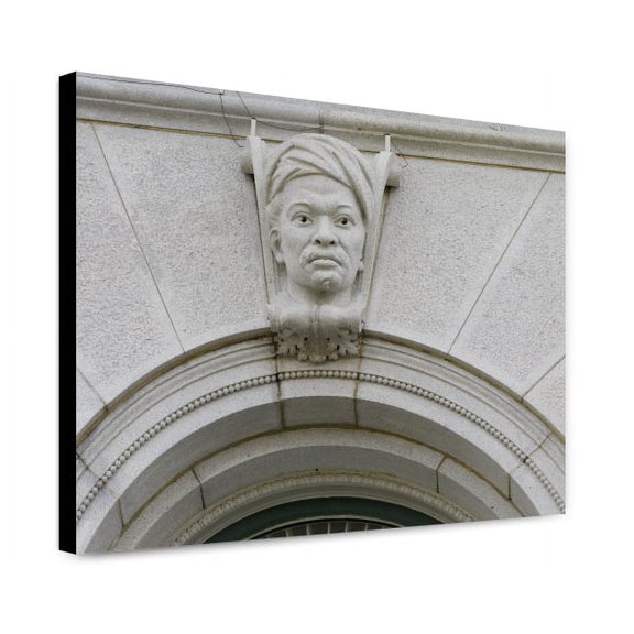 Canvas Print: Exterior View. Ethnological Head On A Keystone Of A First Story
